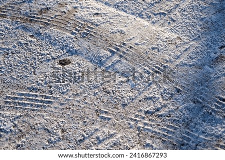 Snow settling on a road during winter cold snap  Royalty-Free Stock Photo #2416867293