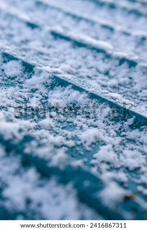 Snow settling on a shed roof during winter cold snap  Royalty-Free Stock Photo #2416867311