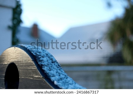 Snow settling on fence during winter cold snap  Royalty-Free Stock Photo #2416867317