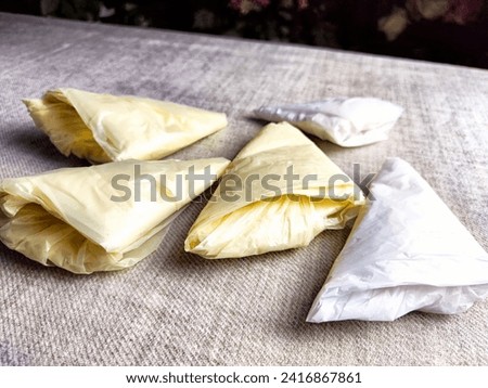 Plastic bag folded into triangle for storage. Ways of storing and laying at home Royalty-Free Stock Photo #2416867861
