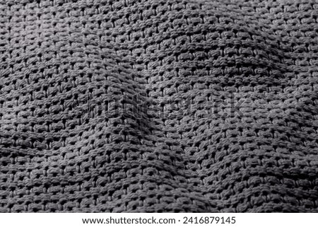 A subtle play of chiaroscuro on gray wavy textile material Royalty-Free Stock Photo #2416879145