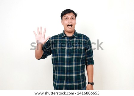 Portrait of young adult Indonesian man standing while showing five fingers. Isolated on white