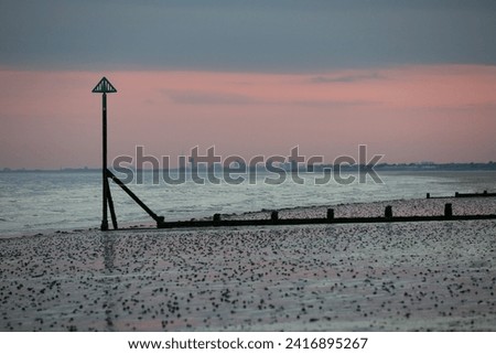 A view of Portsmouth from East Wittering beach. The picture was taken early evening after sunset. Rain clouds are moving towards the city.