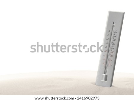 Weather thermometer in sand against white background Royalty-Free Stock Photo #2416902973