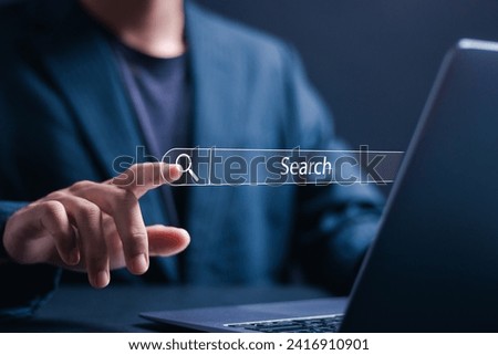 Data search technology search engine optimization concept. Businessman using laptop with virtual Search bar for data search on website online.