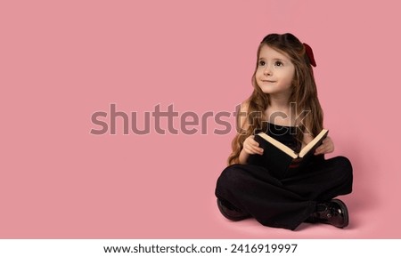 The picture of the little girl with very beautiful hair, surprised by how she reads books and is very attracted to reading and learning. Fetitza is very smart and fat.