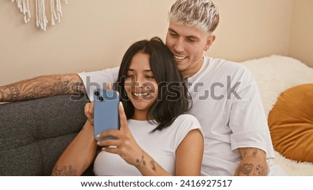 A couple in love takes a selfie in a cozy living room, showcasing their beautiful relationship and togetherness indoors.
