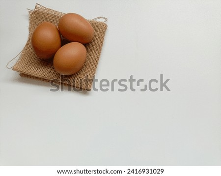 Chicken eggs on burlap sack on white background. isolated chicken eggs