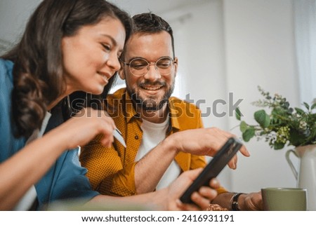 Couple caucasian man and woman husband and wife or boyfriend and girlfriend use laptop computer and credit card shopping online buy stuff or pay make payment booking e-commerce from home real people Royalty-Free Stock Photo #2416931191