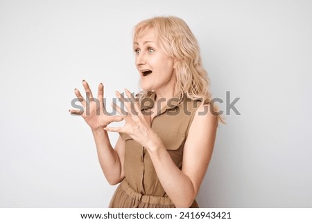 Portrait adult woman happy face smiling joyfully with raised palms and shocked open mouth isolated on white studio background
