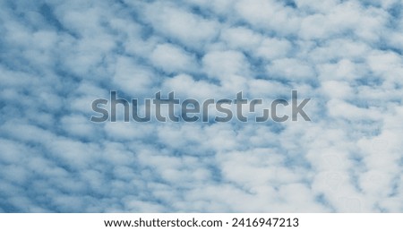 Small clouds on the blue sky, abstraction, background, surface movement.