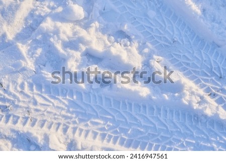 Texture of a car tire imprint on the snow.