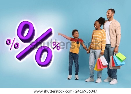 Discount offer. Family with shopping bags looking at percent signs on light blue background