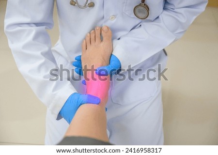 A doctor is examining the ankle of a woman who has an ankle injury. Foot treatment with an orthopedic surgeon will treat pain caused by uncomfortable shoes Royalty-Free Stock Photo #2416958317