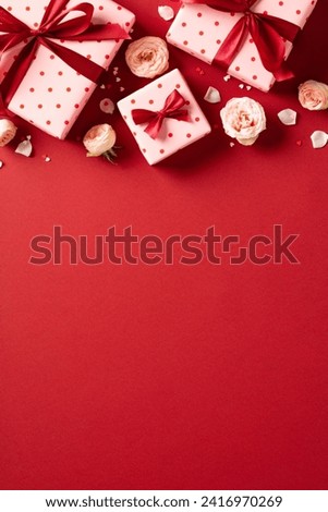 Valentine's Day vertical background, poster design. Flat lay Valentines gift boxes decorated ribbon bows, roses buds on red background.