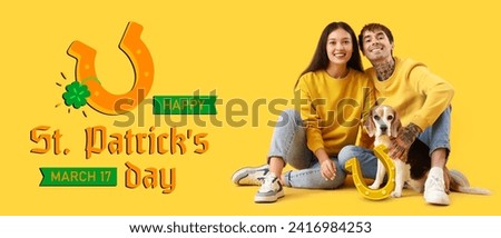 Young couple with Beagle dog on yellow background. Banner for St. Patrick's Day