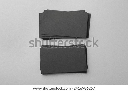 Blank black business cards on light background, top view. Mockup for design
