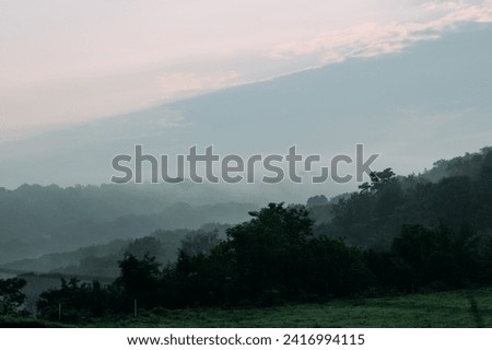 Rolling hills above a valley in rural Pennsylvania with fog