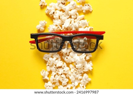 Popcorn and 3D glasses on color background