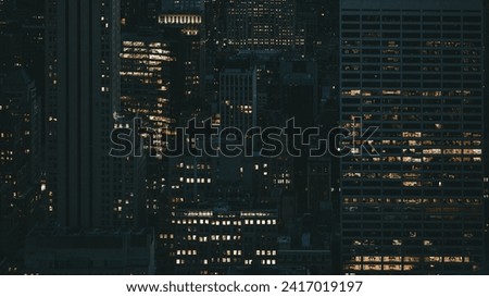 Offices with lighted windows at night in New York city