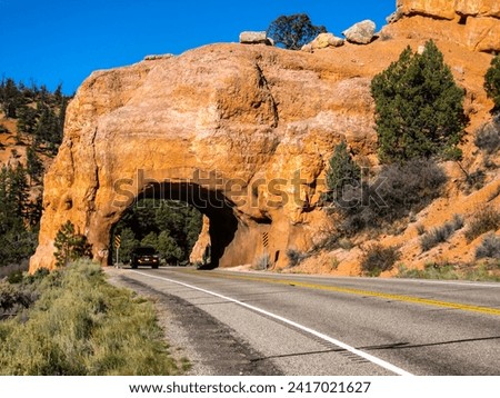 Seemingly enchanted arch over the road, cut into the red limestones of the red canyon along Scenic Byway 12 in Utah. Royalty-Free Stock Photo #2417021627
