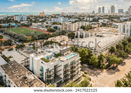 Aerial drone photoshoot Footage in Florida, USA, commercial area, luxury houses, buildings and mansions, abundant tropical vegetation around, beautiful blue sky.