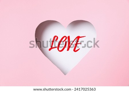 Beautiful heart with a word "Love"on a pink background