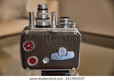 Vintage Film Camera with Red Dials on Polished Surface
