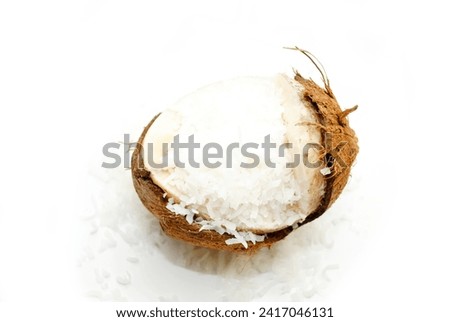 Broken Coconut with Shredded Coconut Spilling Out