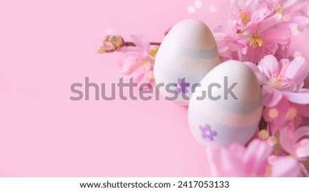 Close up of easter eggs and cherry flowers on a pink background with bokeh and copy space. Church Christian holidays, Christianity, Easter background