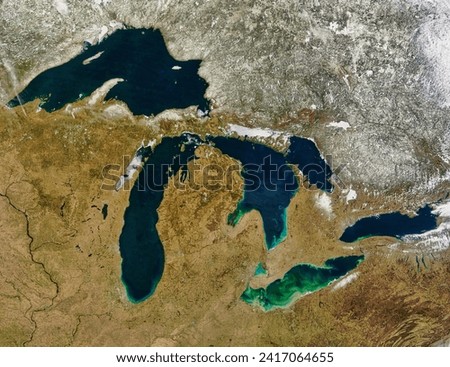 The Great Lakes. The Great Lakes of North America  Superior, Michigan, Huron, Ontario, and Erie  mark a dividing line between the stillsnowy. Elements of this image furnished by NASA. Royalty-Free Stock Photo #2417064655