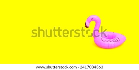 Inflatable ring on yellow background.