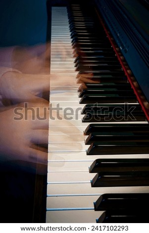 A piano with hands in motion.