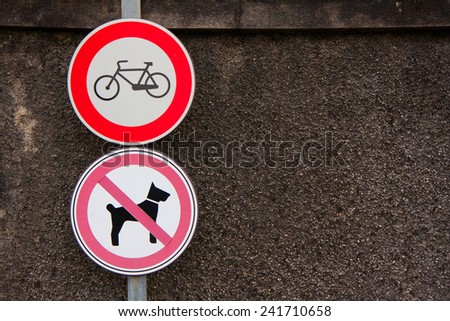 two signs prohibiting bicycles and dogs