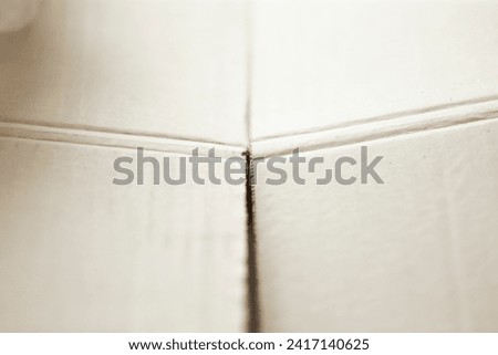 Close up of white paper board texture useful as a background or wallpaper.