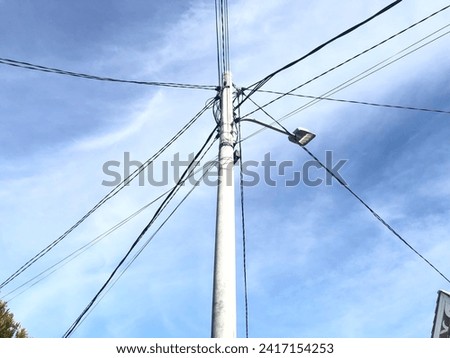 25 January 2025. Electric pole with high voltage cables and residential street lights.