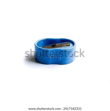 A rusty blue pencil sharpener isolated on a white background