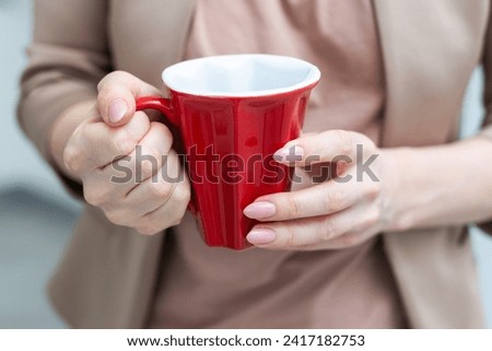 Woman holding mug of hot drink, closeup. Coffee Break Royalty-Free Stock Photo #2417182753