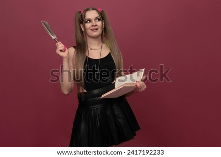 Woman writes in her notebook isolated on red background