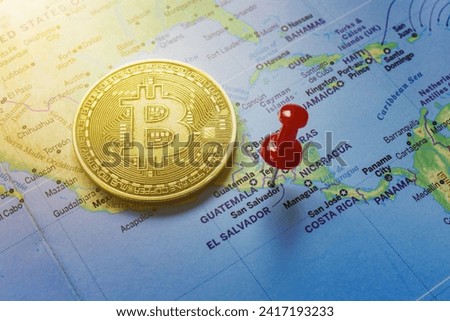 A red pin is pinned on the world map of El Salvador and there is a bitcoin next to it.
