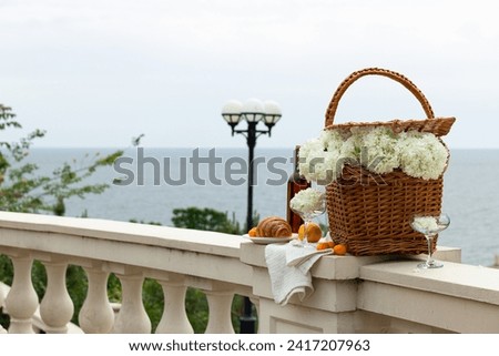 A picnic for two, in the summer, with a view of the sea.
