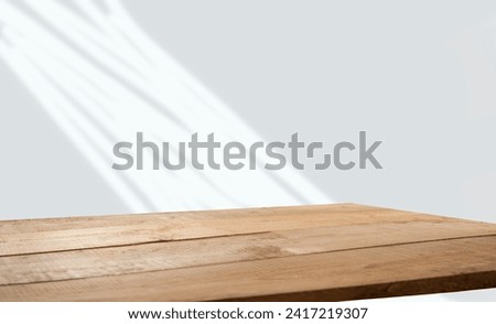 empty table with window shadow on light wall background for product mockup display. kitchen interior theme Royalty-Free Stock Photo #2417219307