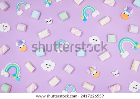 Trendy pastel purple kawaii background with cute air plasticine handmade cartoon animals, unicorns, clouds, rainbows, sweet marshmallows pattern. Top view, flat lay. Candycore, fairycore.