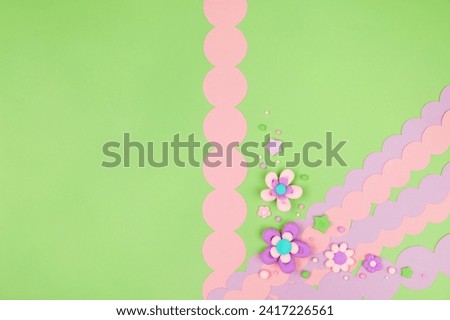 Trendy pastel green kawaii banner background design template with cute air plasticine handmade cartoon flowers decorative border. Top view, flat lay, copy space. Candycore, fairycore design template