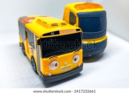 yellow children's toys, namely buses and excavator trucks