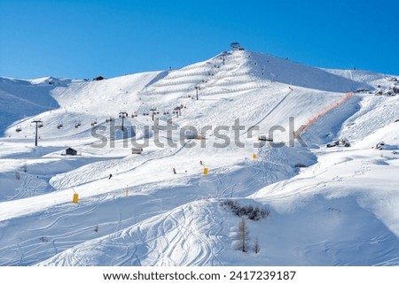 Ski resort in the Dolomites. Mountain recreation place. Ski slopes in the Dolomites on a clear sunny day. Alpine skiing sport and recreation. Royalty-Free Stock Photo #2417239187