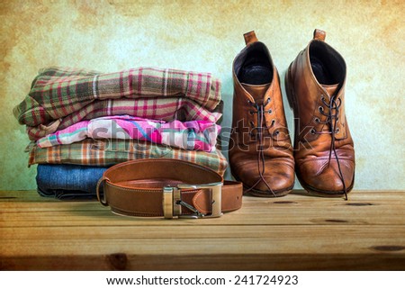 Still life with casual man on wooden table over grunge background
