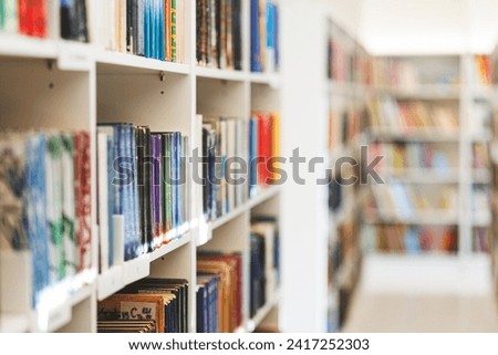 Books on the bookshelf in public library. High quality photo
