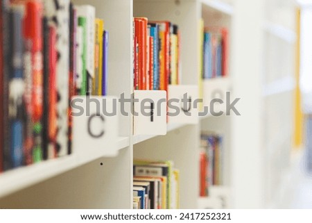 Books on the bookshelf in public library. High quality photo