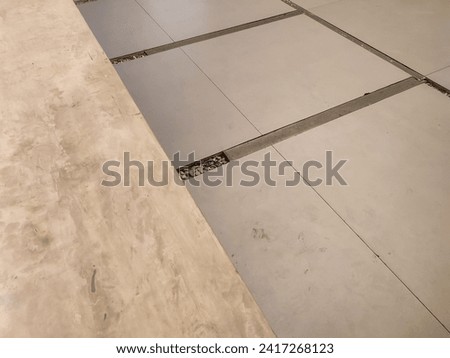 Minimalist gray background of tile floor pattern in hotel.  Negative space.